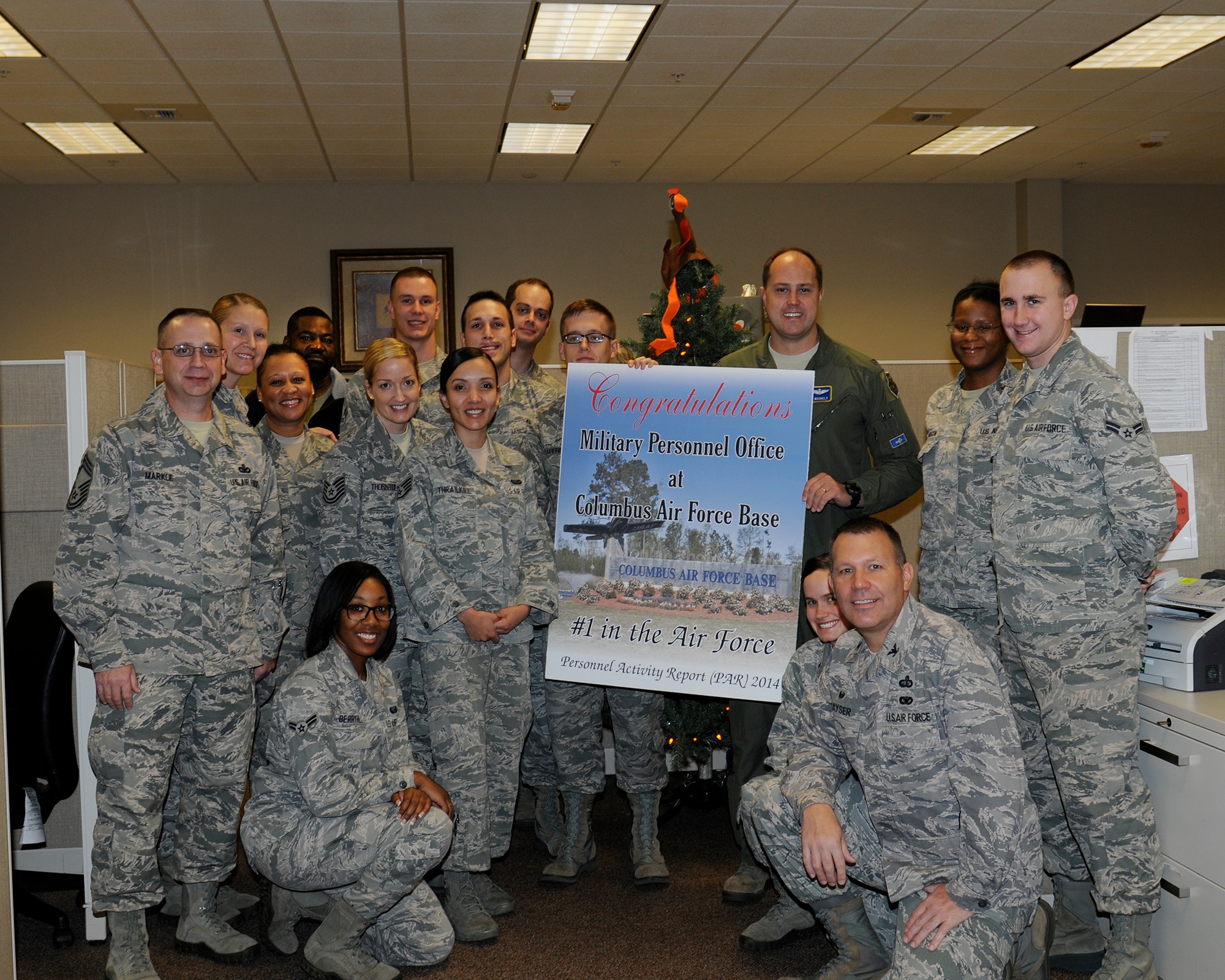 Col. John Nichols, 14th Flying Training Wing Commander, and Chief Master Sgt. Rita Felton, 14th Flying Training Wing Command Chief, pause for a photo with the 14th Force Support Squadron Military Personnel Flight Nov. 25 after recognizing their hard work for earning the No. 1 ranking for Personnel Action Reports at the Air Force level in Fiscal 2014. Areas that were scored included form discrepancies, evaluation timeliness, evaluation error rates and Permanent Change of Station error rates. (U.S. Air Force photo/Melissa Doublin)