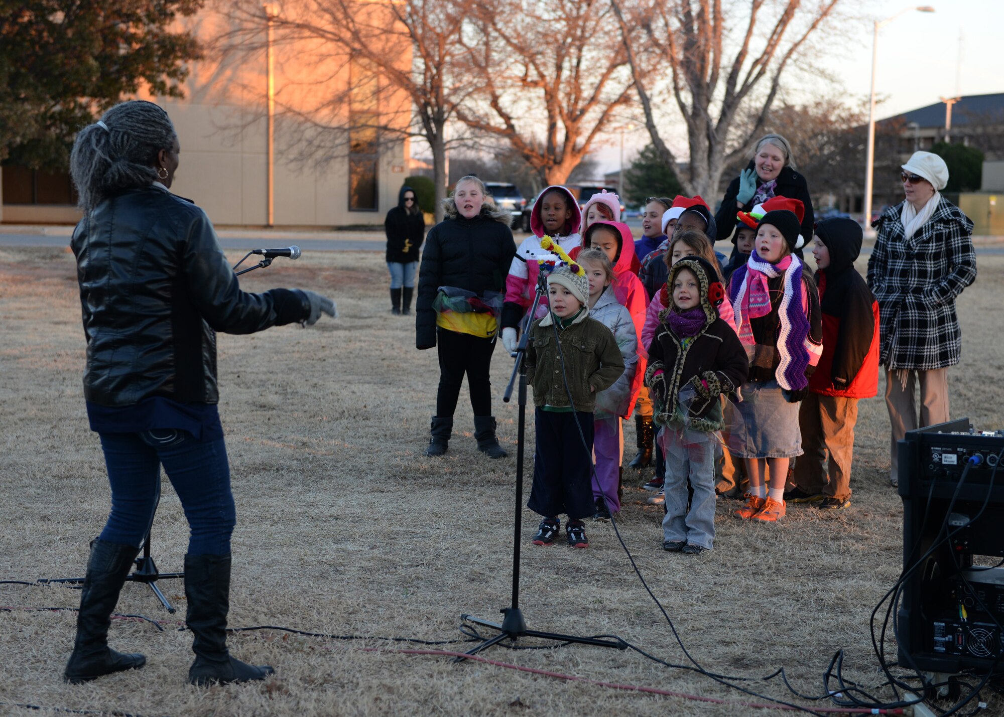 ALTUS AIR FORCE BASE, Okla. – Children sing “I want a Hippopotamus for Christmas” as part of the Christmas tree lighting ceremony at Wings of Freedom Park Dec 1, 2014. The ceremony had groups of carolers, cookies and hot chocolate and a visit from Santa Claus to kick off the holiday season. (U.S. Air Force photo by Airman 1st Class Megan Acs/Released) 