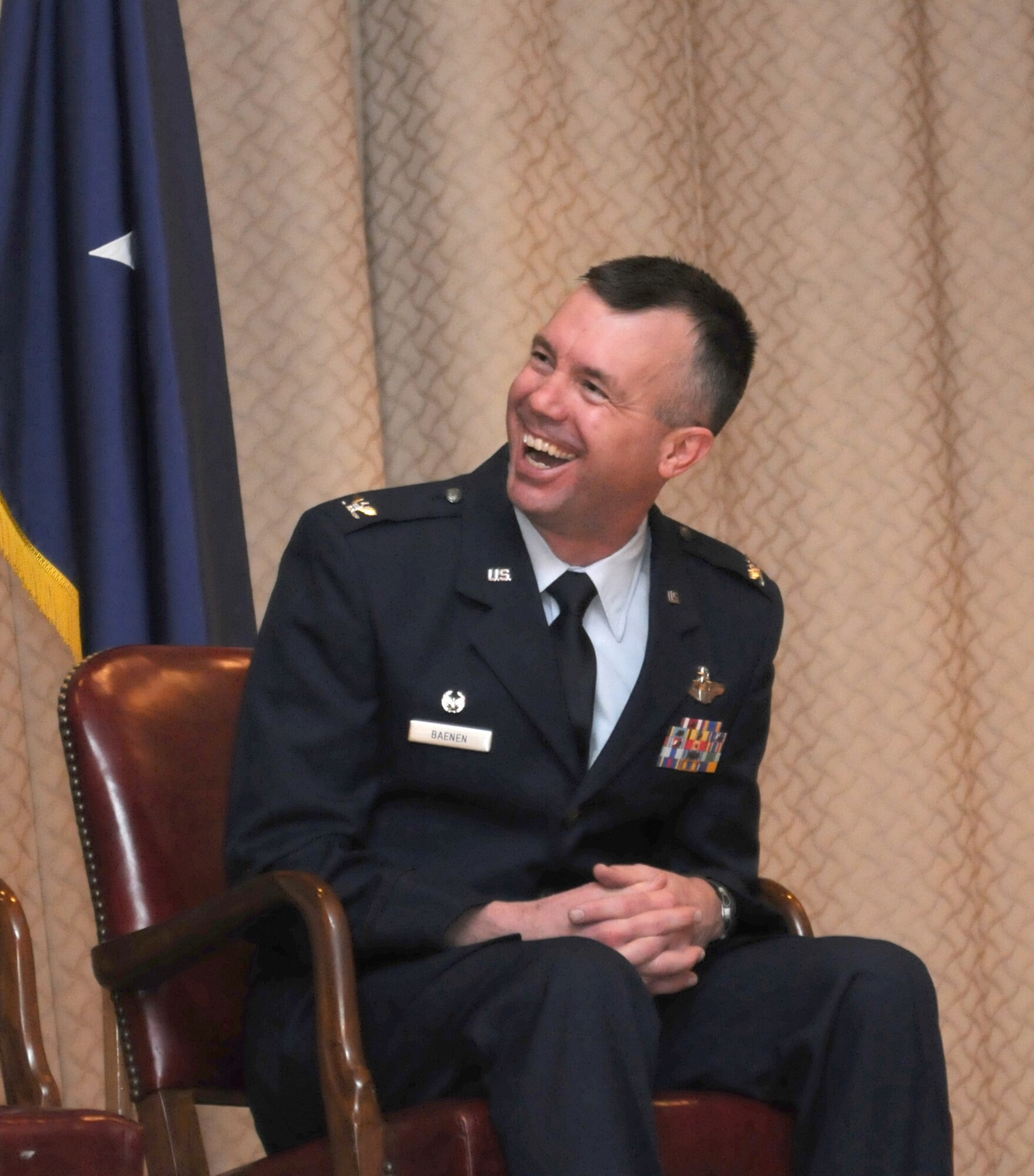 Col. Jeremy O. Baenen wears his signature ear-to-ear grin during one of many laughs during his retirement ceremony, Nov. 21, 2014 at Kingsley Field in Klamath Falls, Ore. He related in his remarks that maintaining a sense of humor is an integral part of his leadership style. (U.S. Air National Guard photo by Tech. Sgt. Jefferson Thompson/Released)