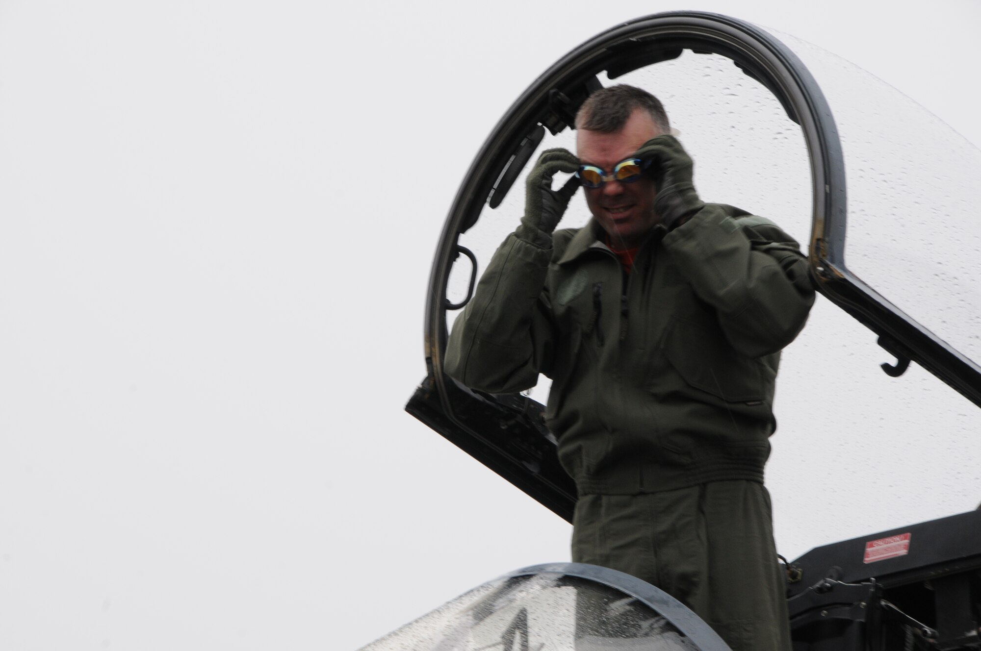 Col. Jeremy “Weed” Baenen, the 173rd Fighter Wing Commander for scant hours before retiring, showcases the forethought that carried him to the helm of the Wing immediately following his “fini flight”, Nov. 21, 2014. The “fini flight” is a tradition among pilots and aircrew where upon disembarking they get hosed down with water. (U.S. Air National Guard photo by Tech. Sgt. Jefferson Thompson/Released)