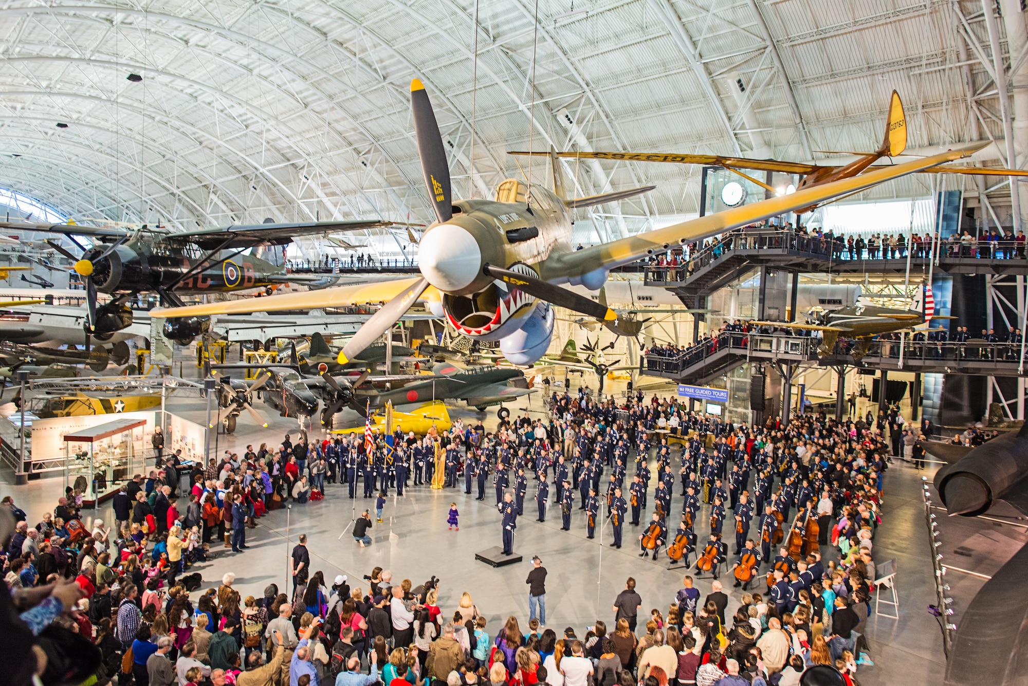 Col. Larry H. Lang, the commander and conductor of The U.S. Air Force Band, addresses the crowd following the Band's 2014 flash mob at the Smithsonian's National Air and Space Museum, Steven F. Udvar-Hazy Center on Tuesday, Dec.2. (U.S. Air Force photo by Senior Master Sgt. Kevin Burns/released)