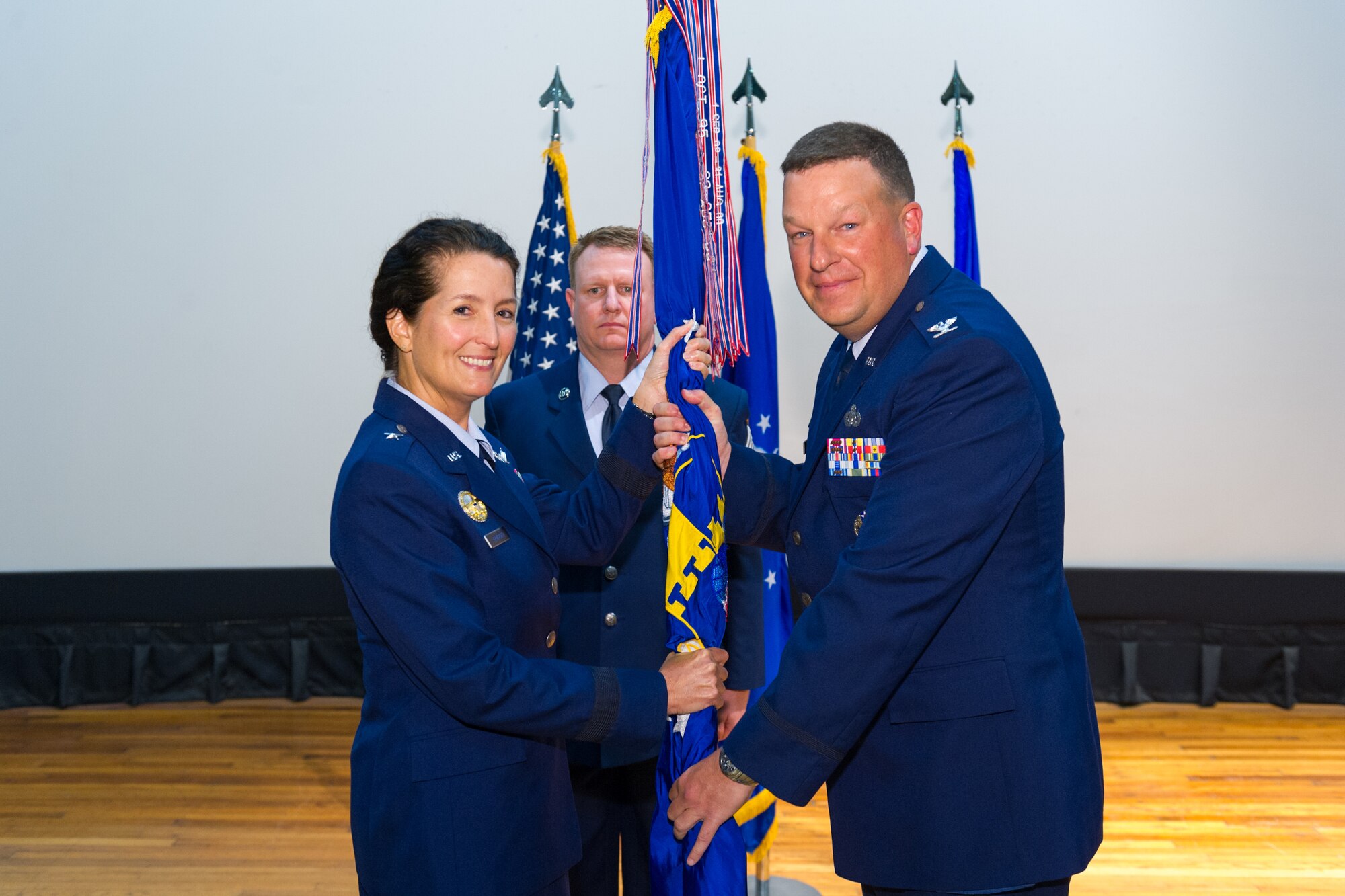 Brig. Gen. Nina Armagno, 45th Space Wing commander, left, presents Col. Matthew Wallace, 45th Mission Support Group commander, with the 45th MSG guidon during a change of command ceremony, Dec.  1, 2014, at Patrick Air Force Base, Fla. Changes of command are a military tradition representing the transfer of responsibilities from the presiding officials to the upcoming official. (U.S. Air Force photo/Cory Long)
