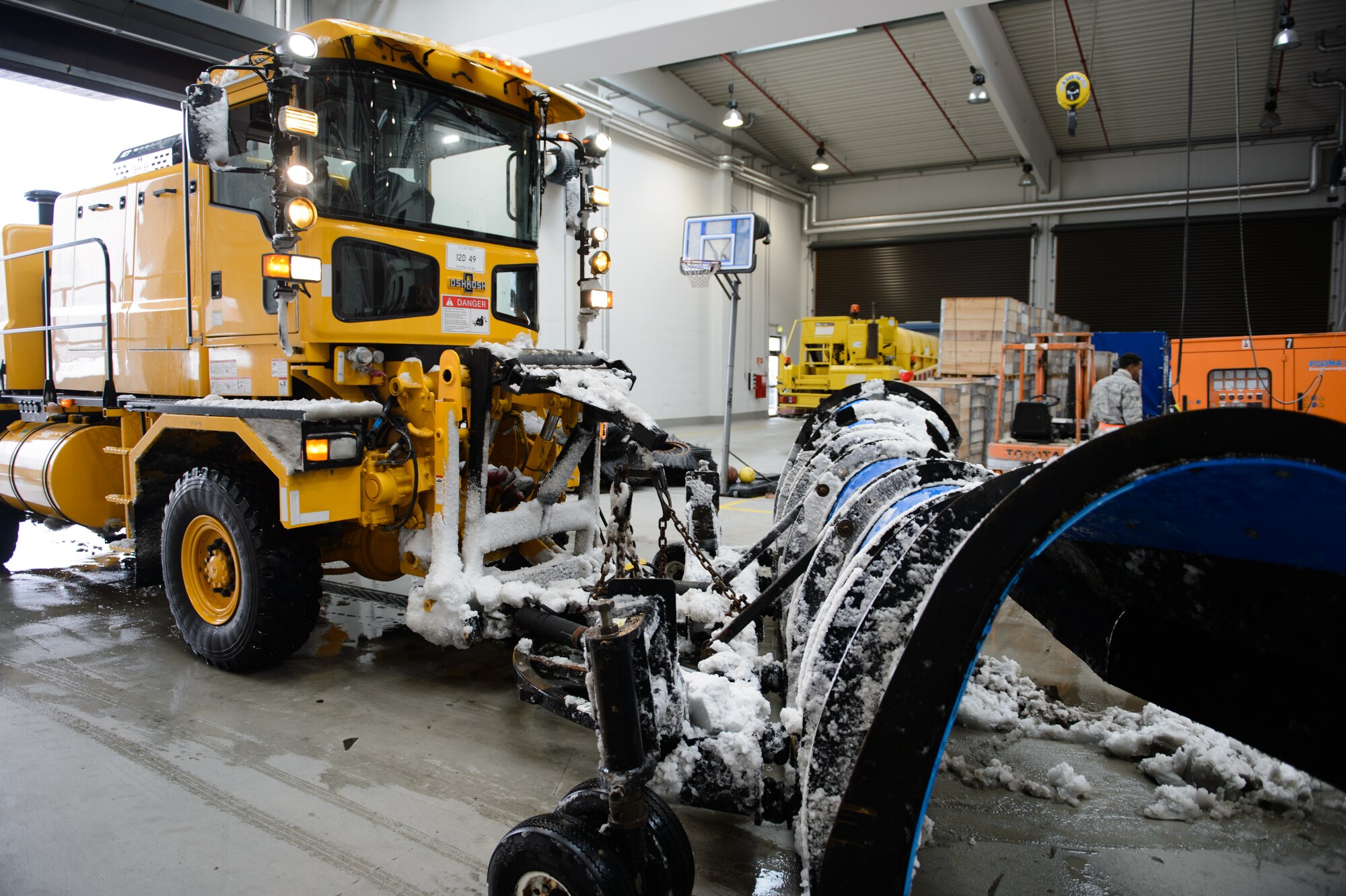 Airmen from the 786th Civil Engineer Squadron heavy equipment shop bring their vehicles in for repairs after plowing much of the flightline, Dec. 3, 2014, at Ramstein Air Base, Germany. The heavy equipment shop sprang into action as the first snow of the season hit the ground to ensure the mission continued. (U.S. Air Force photo/ Senior Airman Armando A. Schwier-Morales)