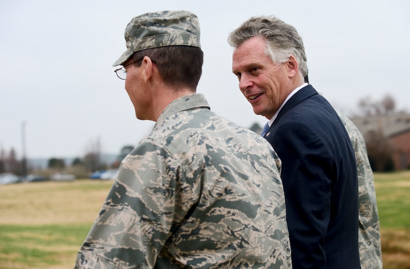 Virginia Gov. Terry McAuliffe is escorted inside the 480th Intelligence Surveillance and Reconnaissance Wing during a visit to Langley Air Force Base, Va., Dec. 2, 2014. Along with gaining a greater understanding of the major military installations in the Commonwealth of Virginia, the governor spoke with U.S. Air Force Airmen and Soldiers to understand their involvement in maintaining the mission capabilities of Joint Base Langley-Eustis. (U.S. Air Force photo by Senior Airman Kayla Newman/Released)