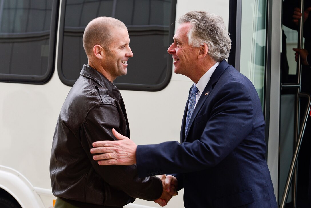Virginia Gov. Terry McAuliffe is greeted by U.S. Air Force Col. Kevin Hyuck, 1st Fighter Wing commander, during a visit to Langley Air Force Base, Va., Dec. 2, 2014. McAuliffe, the 72nd governor of Virginia, visited several locations on Joint Base Langley-Eustis and spoke to U.S. Airmen and Soldiers about their involvement in maintaining the mission capabilities of JBLE. (U.S. Air Force photo by Senior Airman Kayla Newman/Released) 