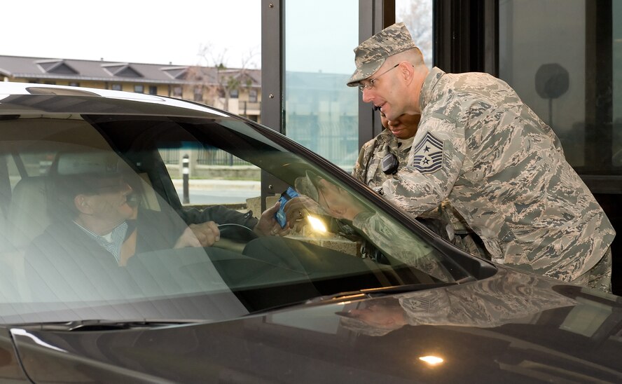 Chief Master Sgt. Stanley Cadell, 436th Airlift Wing command chief, hands out a first aid kit to a driver as he enters the base Nov. 25, 2014, at the main gate on Dover Air Force Base, Del. As part of the Wing's Safety Send Off, Cadell reminded drivers and passengers to be safe over the Thanksgiving Day holiday as they entered the main gate to the base. (U.S. Air Force photo by Roland Balik)