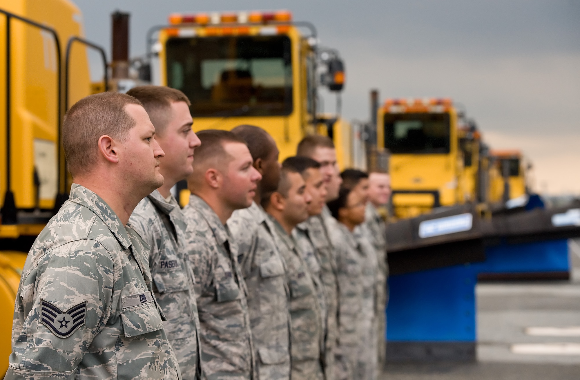 Members of the 436th Civil Engineer Squadron Horizontal Shop wait for wing leadership to arrive for the annual snow parade Nov. 6, 2014, on Dover Air Force Base, Del. Commonly referred to as "Dirt Boyz," they assisted wing leadership with driving airfield snow plow, blower and broom type vehicles down the flight line as a sign that Dover AFB is ready to keep the mission moving as winter weather approaches.(U.S. Air Force photo by Roland Balik)