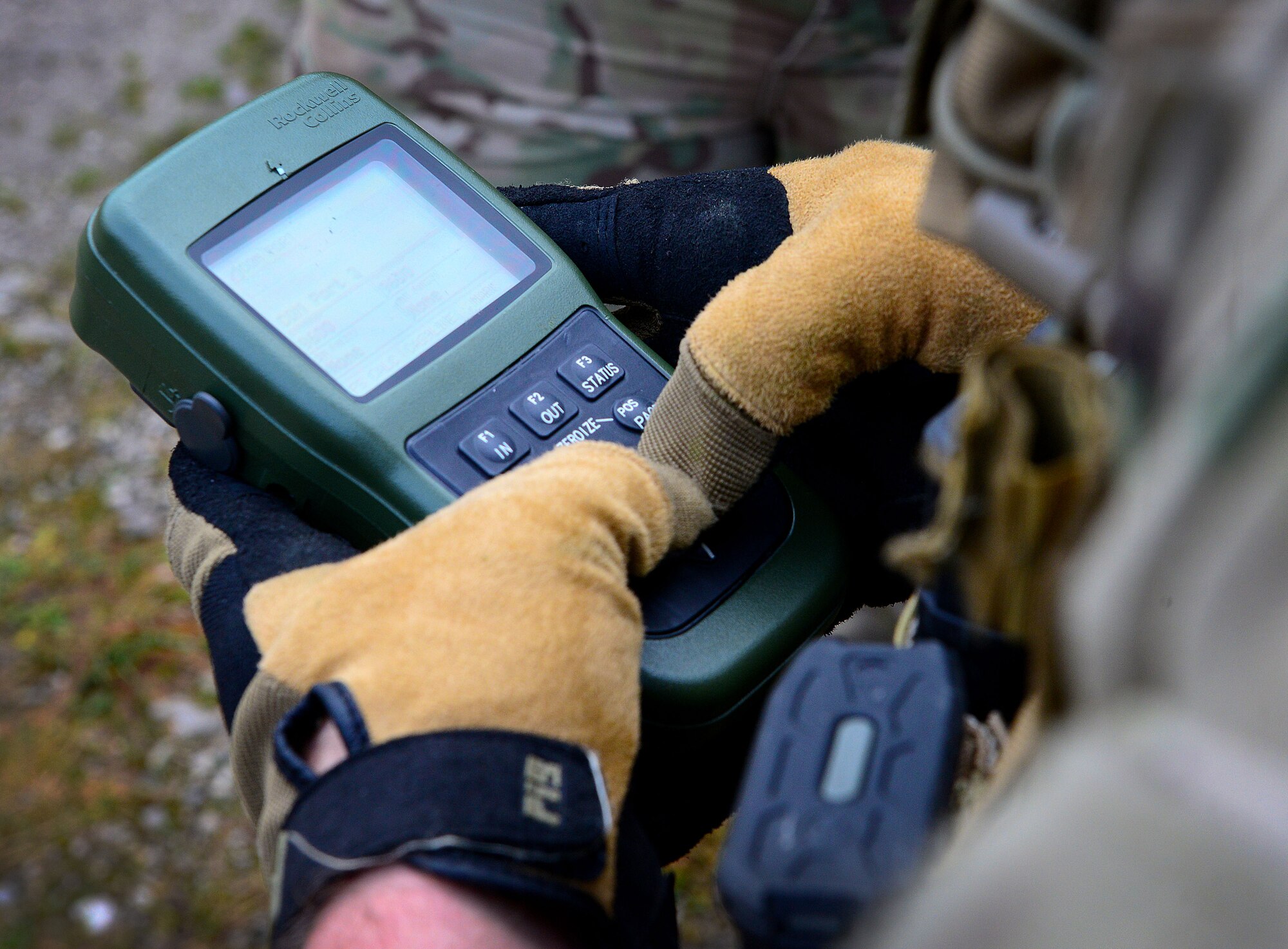 Airman 1st Class Matthew Smith, 2nd Air Support Operations Squadron joint tactical air controller, looks at coordinates for an airstrike on a GPS, Dec. 2, 2014, in Barcis, Italy. During a week-long exercise, U.S. military and the Dutch army are training with 555th Fighter Squadron pilots to stay current in their proficiencies.  The training allows JTACs to coordinate with F-16 Fighting Falcons and practice calling in airstrikes on simulated targets in the mountains. (U.S. Air Force photo/Senior Airman Matthew Lotz)