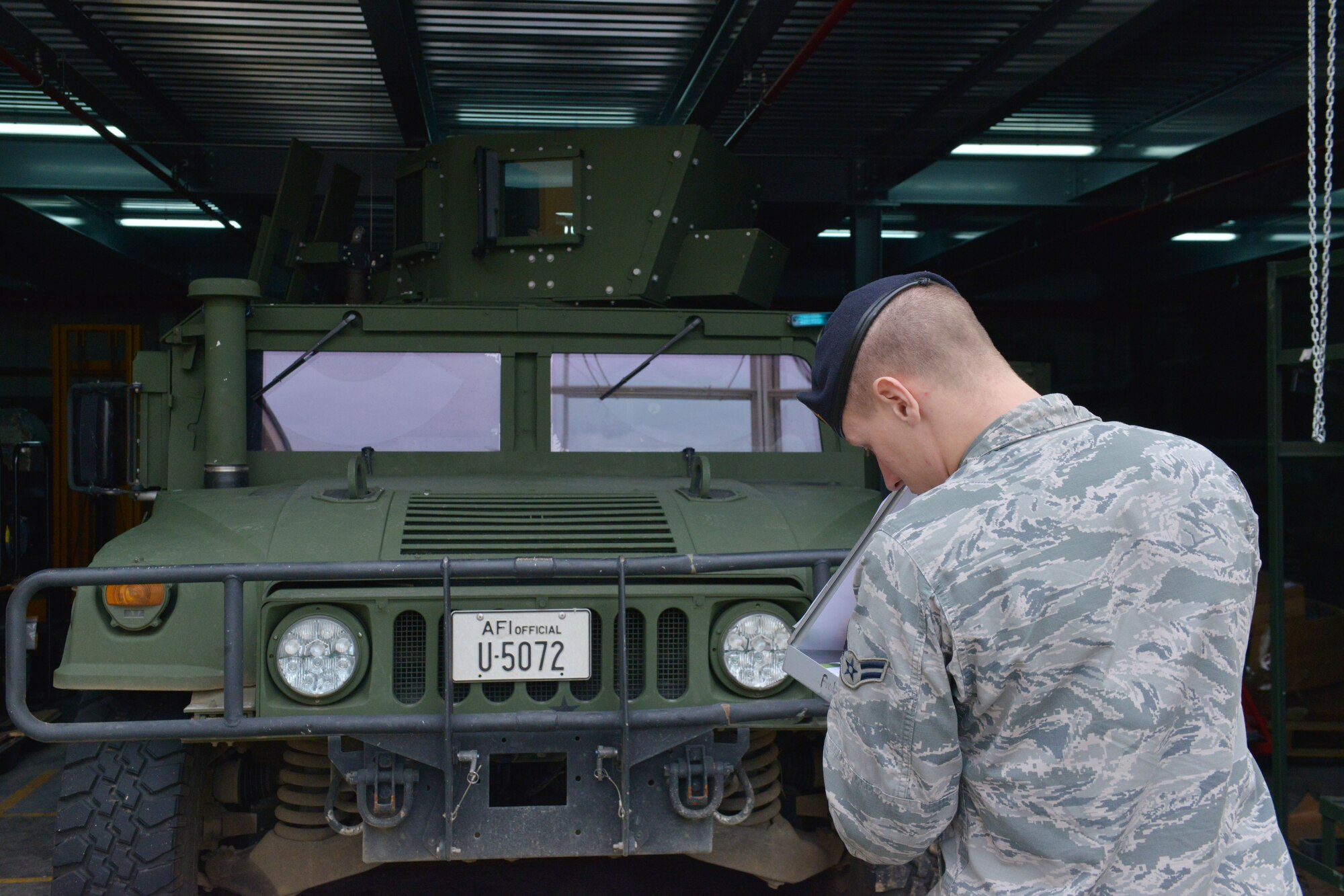 Airman 1st Class Michael Wychcock, 31st Security Forces Squadron assistant vehicle control officer, conducts an inspection on a Humvee, Dec. 12, 2014, at Aviano Air Base, Italy. Wychock is in charge of vehicle inspections, end of month mileage checks and setting up contracts for lights, radios, public addressing systems and weapons racks for security forces vehicles. (U.S. Air Force photo/Airman 1st Class Ryan Conroy) 
