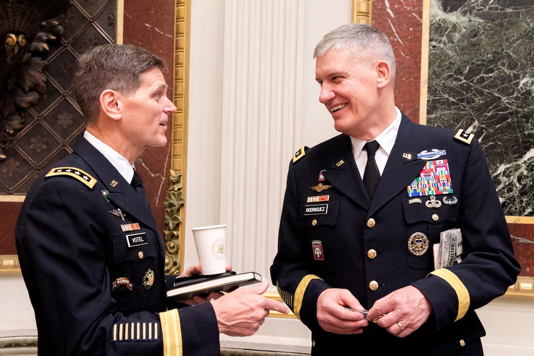 Army Gen. Joseph L. Votel III, left, commander, U.S. Special Operations Command, and Army Gen. David M. Rodriguez, commander of U.S. Africa Command, speak during a strategic studies seminar at the Eisenhower Executive Office Building in Washington D.C., Dec. 2, 2014. 