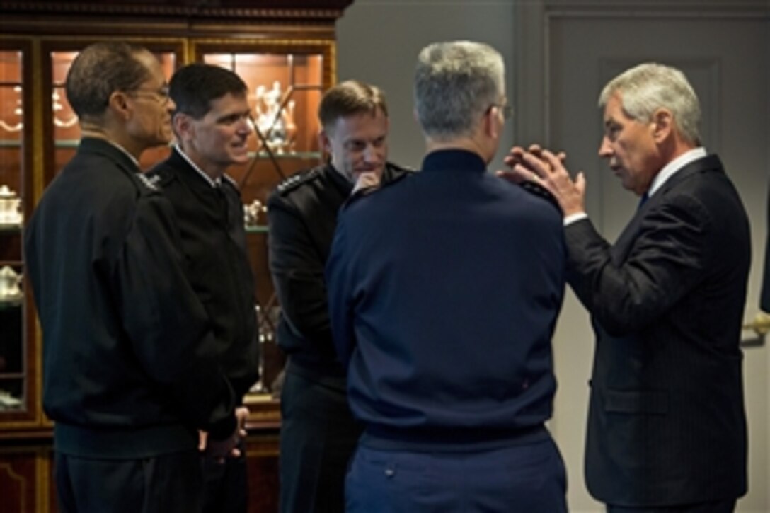 Defense Secretary Chuck Hagel talks with senior military leaders as he hosts a senior leadership council meeting at the Pentagon, Dec. 3, 2014.