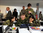 Capt. Jolana Fedorkova, Capt. Jan Sulc, Capt. Miroslava Stenclova and 1st Lt. Denisa Smitalova, all of the Czech Republic Armed Forces, look at some materials during the annual Texas Military Forces Public Affairs Conference Feb. 23-24, 2010.
