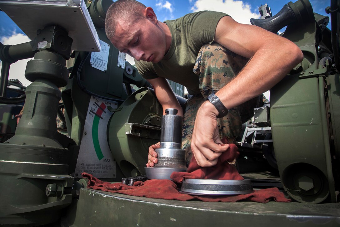 Lance Cpl. Johnathan Dowden, from Wichita Falls, cleans a spindle from an M777A2 lightweight 155 mm howitzer during a command post exercise Oct. 30 for Artillery Training Relocation Program 14-3 at Camp Fuji. The exercise focused on communications between the fire direction center and teams manning the howitzers. ARTP prepared artillery batteries for a smooth execution of training in the North Fuji Maneuver Area by affording teams a chance to troubleshoot any problems with their weapons before moving to the live-fire training. Dowden is an artilleryman with Battery I, 3rd Battalion, 11th Marine Regiment, based out of Twentynine Palms, Calif., and is currently assigned to 3rd Bn., 12th Marine Regiment, 3rd Marine Division, III Marine Expeditionary Force, under the unit deployment program. 