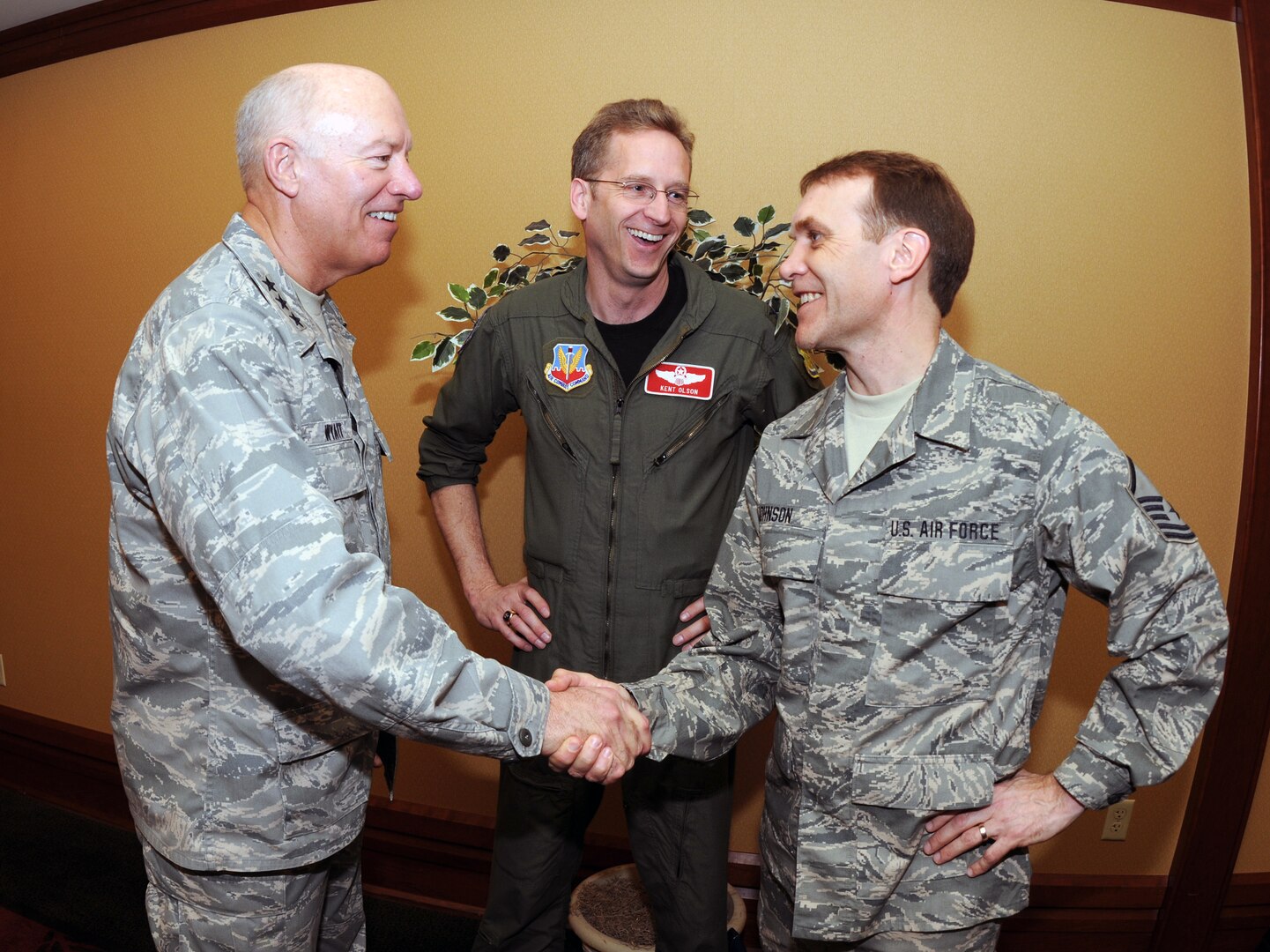Lt. Gen. Harry M. Wyatt III, the director of the Air National Guard, left, shakes hands with Senior Master Sgt. Eric Johnson of the 119th Wing of the North Dakota Air National Guard. Wyatt and Army Maj. Gen. Ray Carpenter, the acting director of the Army National Guard, visited with nearly 500 North Dakota Guard members, who were gathered for the Professional Development Workshop and Combined Associations Conference in Fargo, N.D., March 12, 2010. Col. Kent Olson, also of the 119th Wing, is in the middle.
