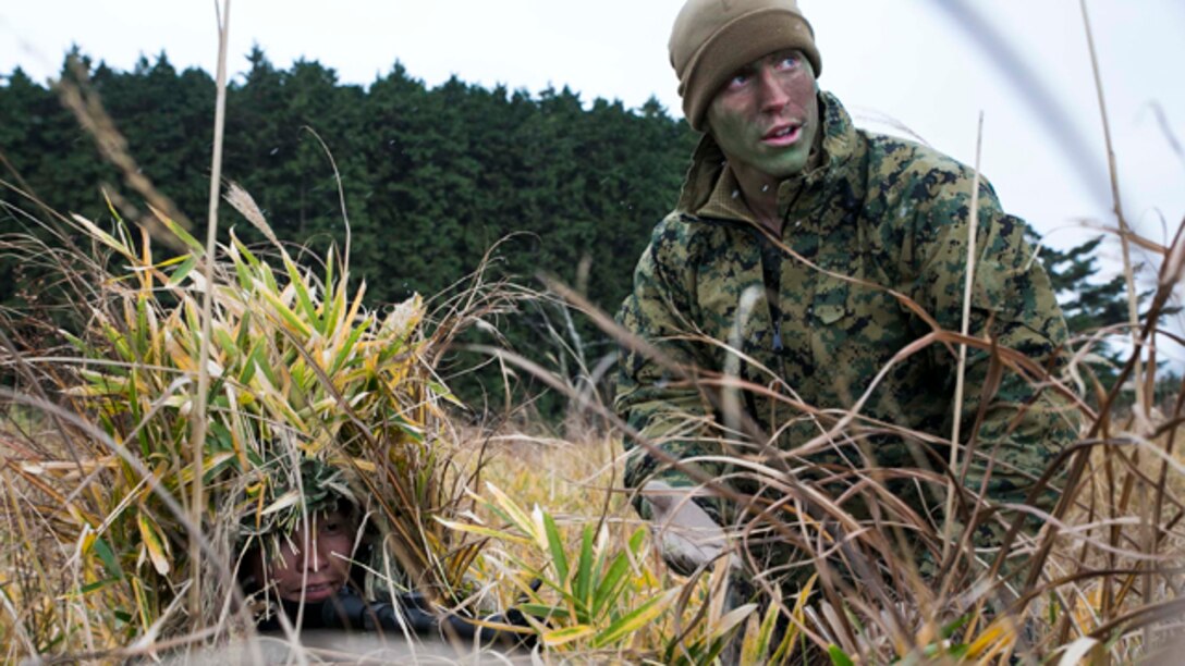U.S. Marine Lance Cpl. Jonas G. Dewald, right, instructs a Japan Ground Self-Defense Force member during sniper stalk lane training Dec. 2 in the Oyanohara Training Area in Yamato, Kumamoto prefecture, Japan. The training is part of Forest Light 15-1, a semi-annual, bilateral exercise consisting of a command post exercise and field training events conducted by elements of III Marine Expeditionary Force and the JGSDF to enhance the U.S. and Japan military partnership, solidify regional security agreements and improve individual and unit-level skills. Dewald, from Wilson, North Carolina, is a machine gunner with Weapons Company, 2nd Battalion, 9th Marine Regiment, currently attached to 4th Marine Regiment, 3rd Marine Division, III MEF, under the unit deployment program. The JGSDF member is with 42nd Regiment, 8th Division, Western Army, JGSDF. (U.S. Marine Corps photo by Cpl. Drew Tech/Released)