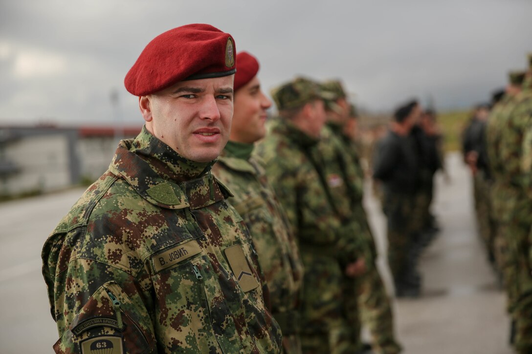 A Serbian soldier along with more than 250 service men and women from seven countries gathered on the parade deck of Serbia's South Base during this year's exercise Platinum Wolf opening ceremony, Nov. 17. Platinum Wolf is a peacekeeping operations training exercise focused on nonlethal systems and basic infantry skills. Units train together as coalitions, developing and improving proficiency of peacekeeping procedures like crowd and riot control. Forces from Bulgaria, Croatia, Macedonia, Romania, Serbia and the U.S. will be participating in the two week training.