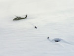 An Alaska Army National Guard UH-60 Blackhawk helicopter sits on Meade
Glacier while Juneau and Douglas mountain rescue teams aid a hiker stranded since March 7, 2010. Army Guard and Coast Guard crews were finally able to reach the hikers location after four unsuccessful Coast Guard attempts due to dense fog and various weather conditions. Alaska State Troopers estimated the area he was stranded in has received 12 feet of snow since Feb. 20.
