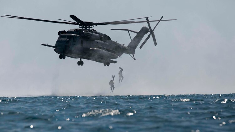 Marines helocast from a CH-53E Super Stallion helicopter Nov. 5 at White Beach Naval Facility during the scout swimmers course. Helocasting requires the Marines to hover 10 feet above the water in an aircraft and jump out with all their gear. The Marines are with various units across III Marine Expeditionary Force. The aircraft is assigned to Marine Medium Tiltrotor Squadron 265 (Reinforced), 31st Marine Expeditionary Unit. 