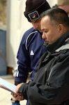 U.S. Army World Class Athlete Program bobsled coach Sgt. Bill Tavares (right) and Army National Guard Outstanding Athlete Program Sgt. Mike Kohn of Virginia peruse a timing chart between runs at Park City, Utah.