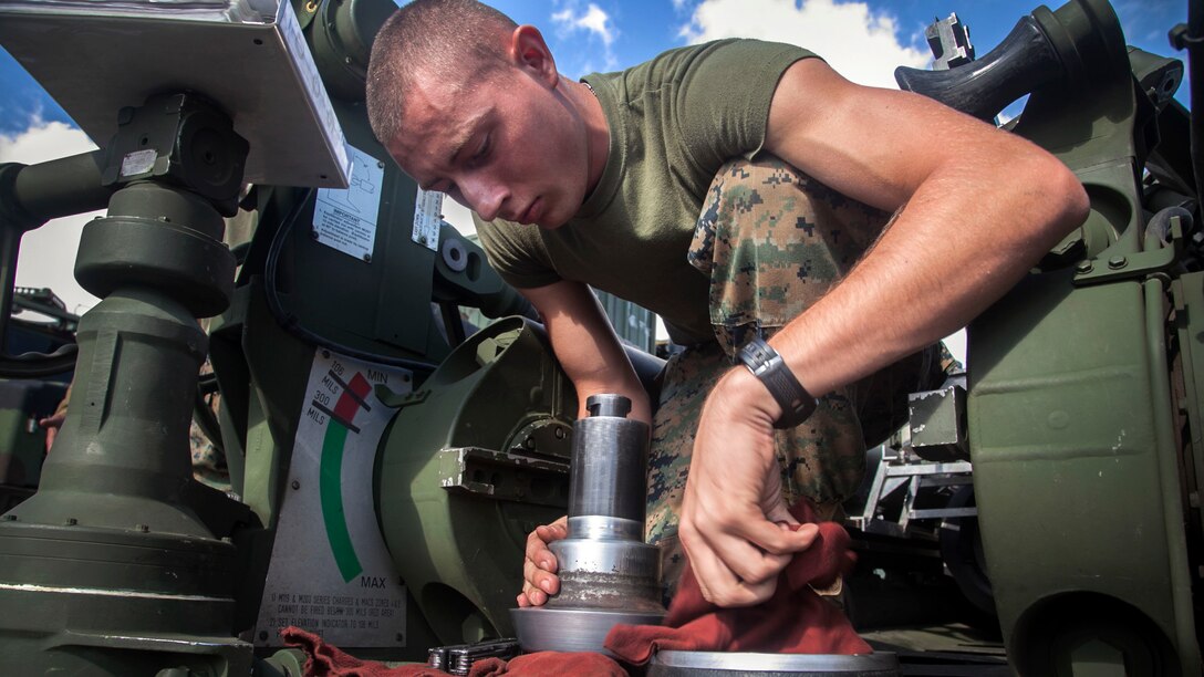 Lance Cpl. Johnathan Dowden, from Wichita Falls, cleans a spindle from an M777A2 lightweight 155 mm howitzer during a command post exercise Oct. 30 for Artillery Training Relocation Program 14-3 at Camp Fuji. The exercise focused on communications between the fire direction center and teams manning the howitzers. ARTP prepared artillery batteries for a smooth execution of training in the North Fuji Maneuver Area by affording teams a chance to troubleshoot any problems with their weapons before moving to the live-fire training. Dowden is an artilleryman with Battery I, 3rd Battalion, 11th Marine Regiment, based out of Twentynine Palms, Calif., and is currently assigned to 3rd Bn., 12th Marine Regiment, 3rd Marine Division, III Marine Expeditionary Force, under the unit deployment program. 