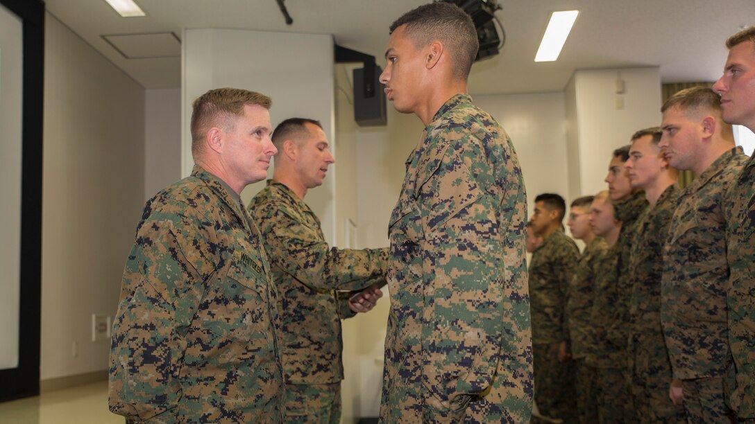 Cpl. Tyler L. Saffore, a bulk fuel specialist with Marine Wing Support Squadron 171, stands before Lt. Col. James Whiteker, MWSS-171 commanding officer, as Sgt. Maj. G.V. Tunnell, MWSS-171 sergeant major, reads aloud a citation stating the things Saffore did to earn the Bulk Fuel Specialist of the Year award, Dec. 3, 2014, aboard Marine Corps Air Station Iwakuni, Japan. Saffore won the award for his strong work ethic, initiative and superior performance. 