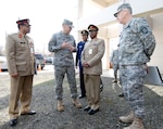 Lt. Col. Lance Englet, commander of the 102 Civil Support Team of the Oregon National Guard, left, briefs Bangladeshi Maj. Gen. Abdul Wadud, principle staff officer for the Armed Forces Division of Bangladesh, on the capabilities and mission of his unit, outside the Anderson Readiness Center, in Salem, Ore., March 7, 2010 as Maj. Gen. Raymond F. Rees, the adjutant general of the Oregon Guard, right, looks on. Members of the Bangladeshi military visited the Anderson Readiness Center and the Oregon Military Department prior to the kick off of the State Partnership Program, March 8-10, held in Portland, Ore.