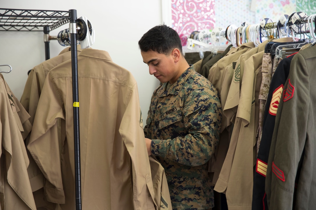 Lance Cpl. Erick Ramirez, an aviation electrician with Marine Aviation Logistics Squadron 26, looks at free uniform items at Ramblin’ Rose Thrift Shop aboard Marine Corps Air Station New River, Nov. 20. All military uniforms and accessories are free to active-duty service members at the thrift shop.