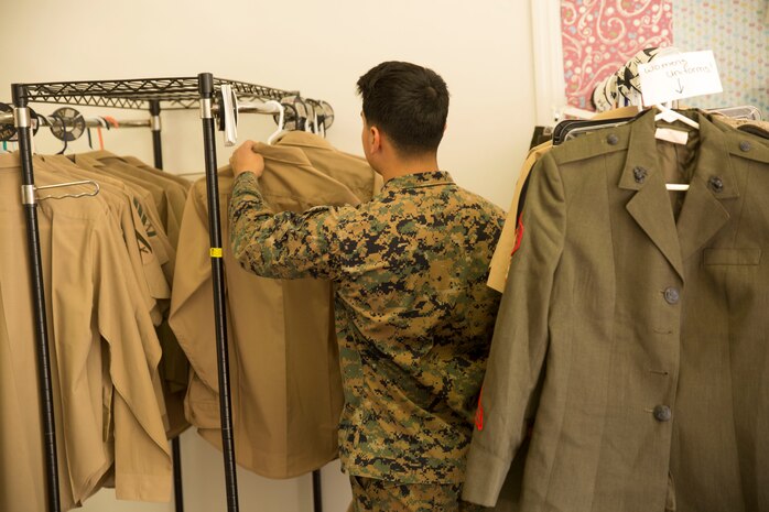 Lance Cpl. Erick Ramirez, an aviation electrician with Marine Aviation Logistics Squadron 26, looks at free uniform items at Ramblin’ Rose Thrift Shop aboard Marine Corps Air Station New River, Nov. 20. All military uniforms and accessories are free to active-duty service members at the thrift shop.