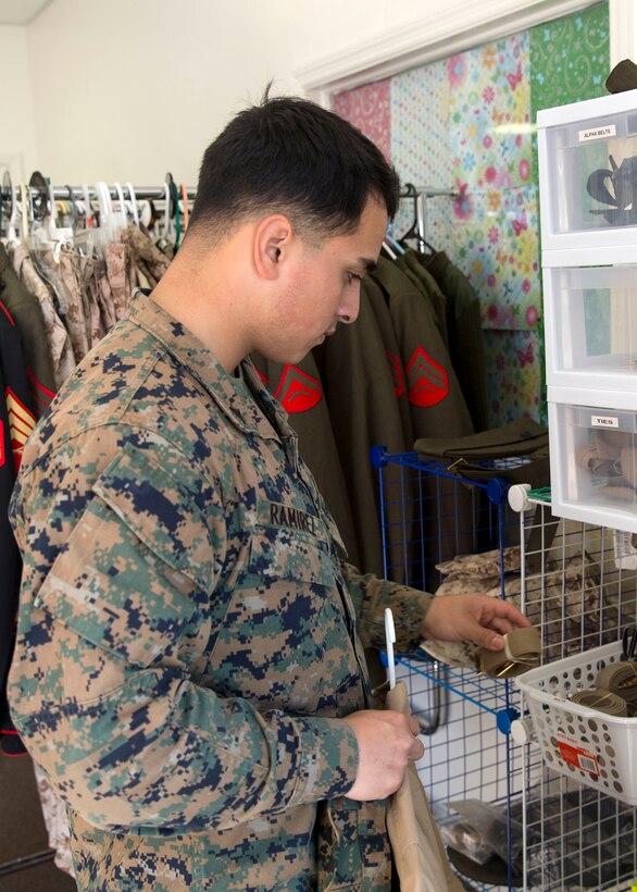 Lance Cpl. Erick Ramirez, an aviation electrician with Marine Aviation Logistics Squadron 26, looks at free uniform items at Ramblin’ Rose Thrift Shop aboard Marine Corps Air Station New River, Nov. 20. All military uniforms and accessories are free to active-duty service members at the thrift shop.