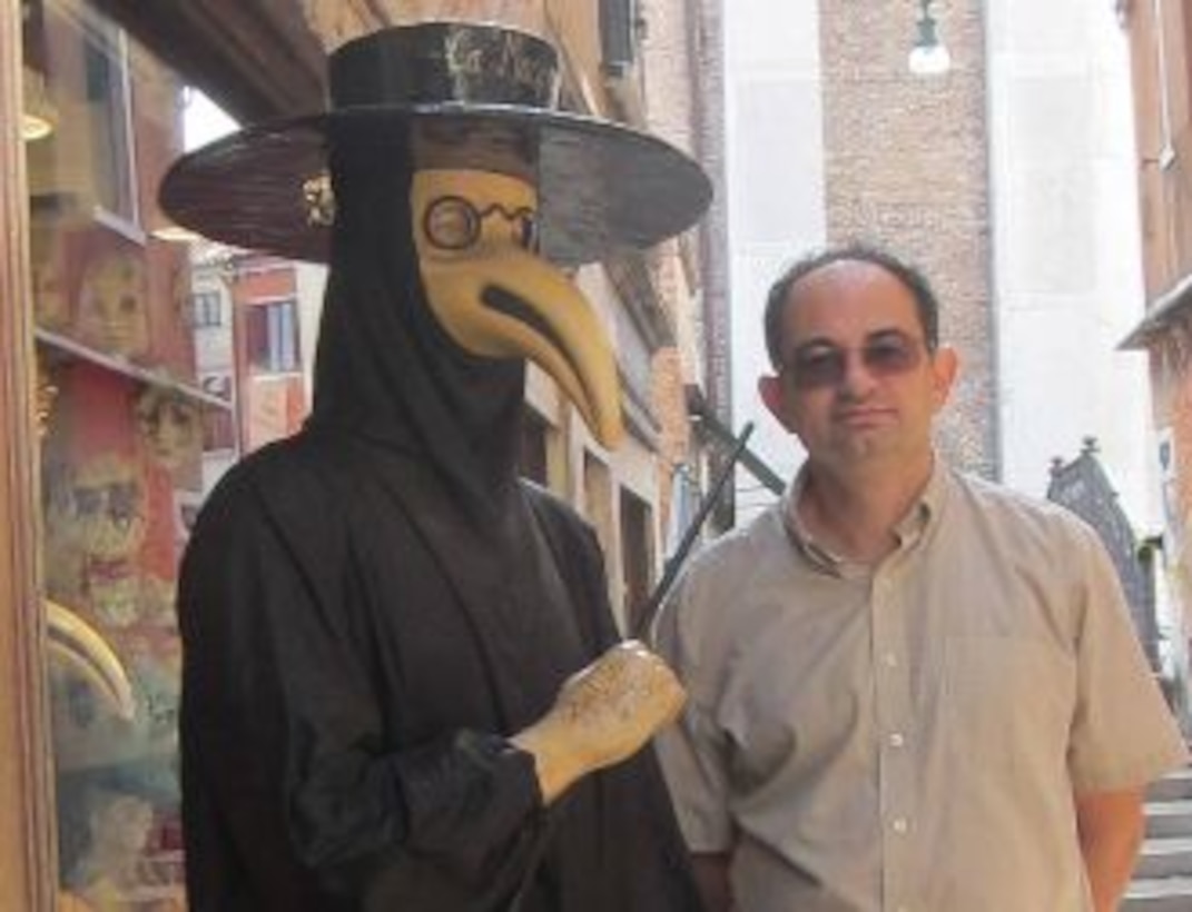 Dr. Igor Linkov, right, with a model in a 14th century plague mask suit, one of the black plague protective measures used by Venetian doctors to try to reduce transmission during the massive epidemic.