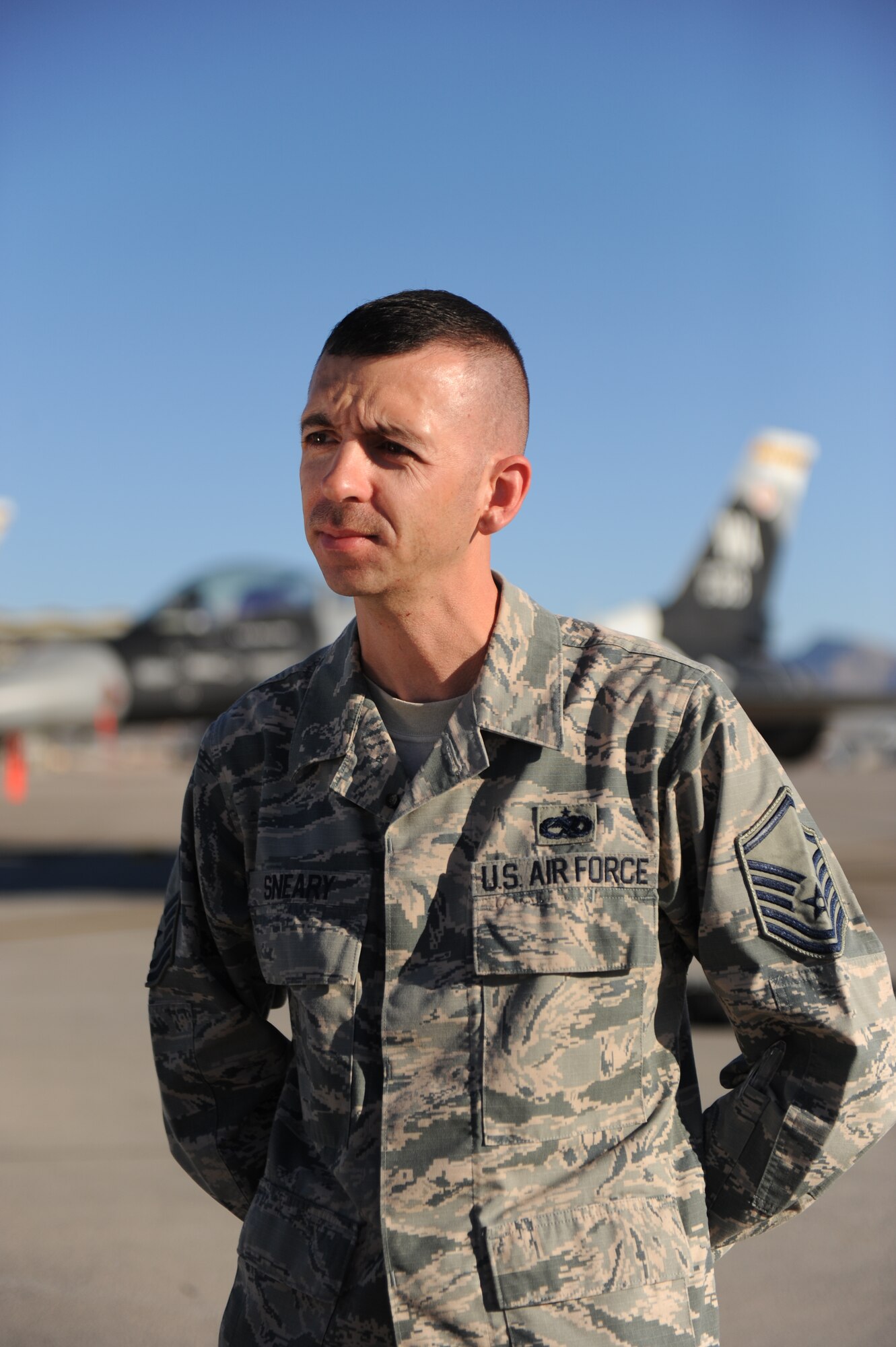 Master Sgt. Shane Sneary answers questions during an interview with the 2nd Combat Camera Squadron Oct. 31, 2014, on the flightline at Nellis Air Force Base, Nev. Sneary was interviewed about his cost saving submission to the Airmen Powered by Innovation program. Sneary is a repair enhancement program manager with the 57th Maintenance Group. (U.S. Air Force photo/Airman 1st Class Mikaley Towle)