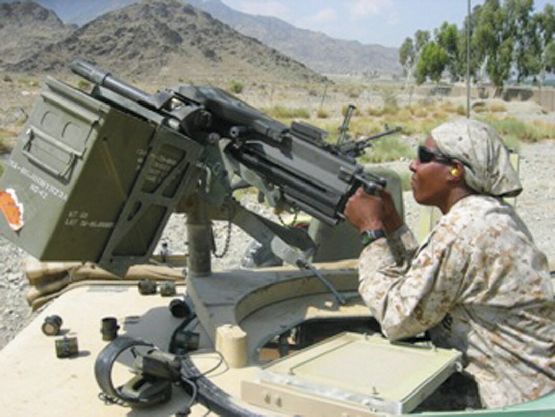 Then-Gunnery Sgt. Carlotta Moore learns how to fire a mounted .50-caliber machine gun with the Special Forces Team in Afghanistan in 2006. During her tour there, she performed the duties of the Administrative Liaison and Senior Enlisted Adviser for Marine Corps Element - Afghanistan and was promoted to master sergeant. 