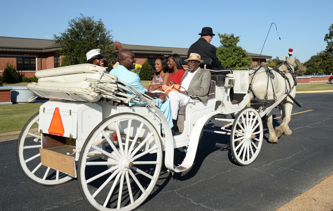 Master Gunnery Sgt. Carlotta Moore pumps her fist as she rides away in style with her family following her retirement ceremony at Marine Corps Logistics Base Albany's Schmid Field, recently. Moore, with Marine Corps Logistics Command, served in many a "clime and place" for 30 years.