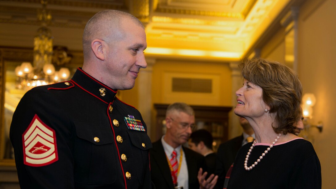 Jason Dean, a Department of Defense Fellow for the Senate Committee on Veterans' Affairs, talks with Lisa Murkowski, the Senior Senator of Alaska at the Senate Committee on Veterans’ Affairs Toys for Tots drive on December 3, 2014. The event was held at the Russell Senate Office Building where 17 boxes were filled with toys.