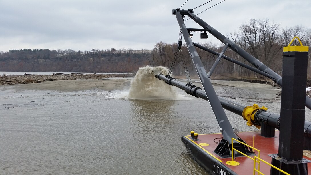 Spill barge Thomas N. George places dredge materials from the Mississippi River to fill  eroded areas near Lock 25 in Winfield, Mo.  US Army Corps of Engineers St. Louis District officials used the Dredge Potter’s flexible pipe assembly to move more than 100,000 cubic yards to stabilize the overflow dike.