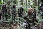 YAMATO, KUMAMOTO, Japan (Dec. 2, 2014) - U.S. Marine Sgt. Joseph Armistead, crouching, instructs Japan Ground Self-Defense Force (JGSDF)Members during sniper stalk lane training in the Oyanohara Training Area.  The training is part of Forest Light 15-1, a semi-annual, bilateral exercise consisting of a command post exercise and field training events conducted by elements of III Marine Expeditionary Force and the JGSDF to enhance the U.S. and Japan military partnership, solidify regional security agreements and improve individual and unit-level skills. Armistead, from Seymour, Tennessee, is a scout sniper with Weapons Company, 2nd Battalion, 9th Marine Regiment, currently attached to 4th Marine Regiment, 3rd Marine Division, III MEF, under the unit deployment program. The JGSDF scout snipers are with 42nd Regiment, 8th Division, Western Army, JGSDF. 141203-M-GX711-105.