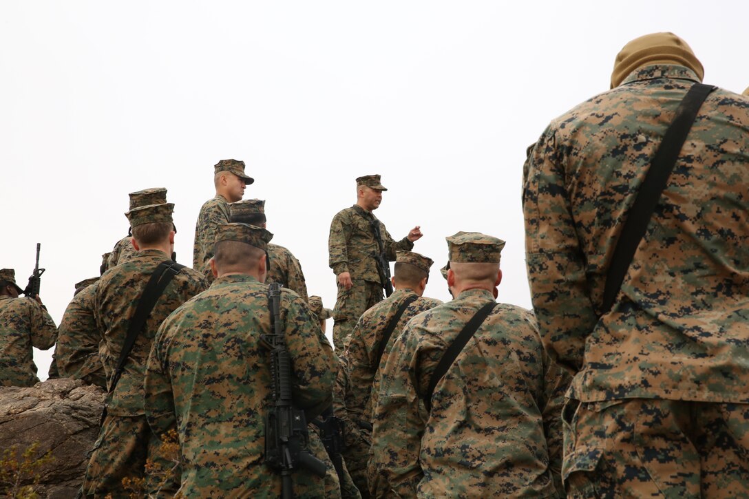 Sgt. Maj. Abel Leal, battalion sergeant major Headquarters Battalion, addresses with the Non-Commissioned Officers of the battalion at the half way point of an NCO hike aboard the Combat Center, Dec. 3, 2014. Leal re-enforced what the NCOs do for the Marine Corps and why it is so important. (Official Marine Corps photo by Lance Cpl. Thomas Mudd/Released)