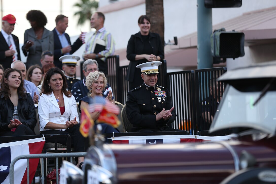 Maj. Gen. Lewis A. Craparotta, Combat Center Commanding General, and his wife Laurie Craparotta clap as a float drives by during the Veterans Day Parade in Palm Springs, Calif., Nov. 11, 2014. (Official Marine Corps photo by Lance Cpl. Julio McGraw/Released)