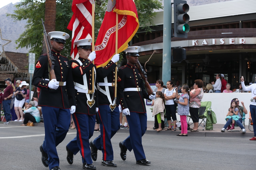 Lance Cpl. Brandon Taylor, administrative specialist, Headquarters Battalion, Sgt. Taylor Hunt, S -1 chief, HQBN, Lance Cpl. Carlos Morris, administrative specialist, Installation Personnel Administrative Center, and Lance Cpl. Carlos Morris, administration specialist, IPAC, march with the colors during the Veterans Day Parade in Palm Springs, Calif., Nov. 11, 2014. (Official Marine Corps photo by Lance Cpl. Julio McGraw/Released)