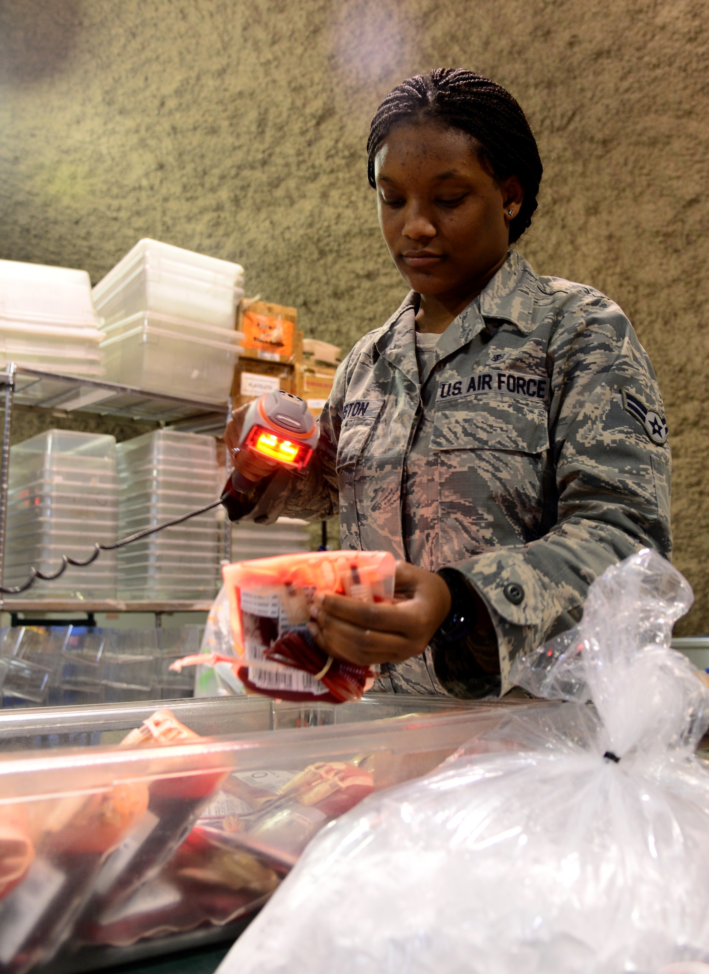 U.S. Air Force Airman 1st Class Jolonda Houston, 379th Expeditionary Medical Group Blood Transshipment Center medical logistician, scans blood products, Dec. 4, 2014, at Al Udeid Air Force Base, Qatar. The BTC here serves as the central point of storage and inventory assessment of all blood products in U.S. Central Command’s Area of Responsibility. The BTC ships and receives over 2,000 blood products a month, which support more than 40 medical treatment facilities throughout the AOR. (U.S. Air Force photo by Senior Airman Kia Atkins)