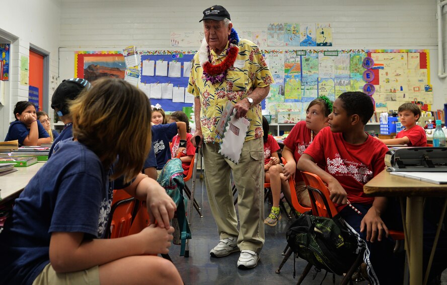 Robert Blum, survivor of the Dec. 7, 1941, attack on Pearl Harbor and Hickam Airfield, speaks with fourth-grade students at Joint Base Pearl Harbor-Hickam, Hawaii, Dec. 4, 2014. The survivors visited the school to commemorate the anniversary of the attack and to share their stories with students and faculty. (U.S. Air Force photo by Staff Sgt. Alexander Martinez/Released) 