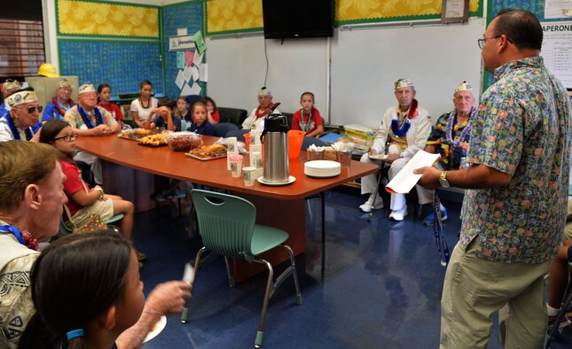 Rory Vierra, Hickam Elementary School principle, welcomes survivors of the Dec. 7, 1941, attack on Pearl Harbor and Hickam Airfield at Joint Base Pearl Harbor-Hickam, Hawaii, Dec. 4, 2014. The survivors visited the school to commemorate the anniversary of the attack and to share their stories with students and faculty. (U.S. Air Force photo by Staff Sgt. Alexander Martinez/Released)