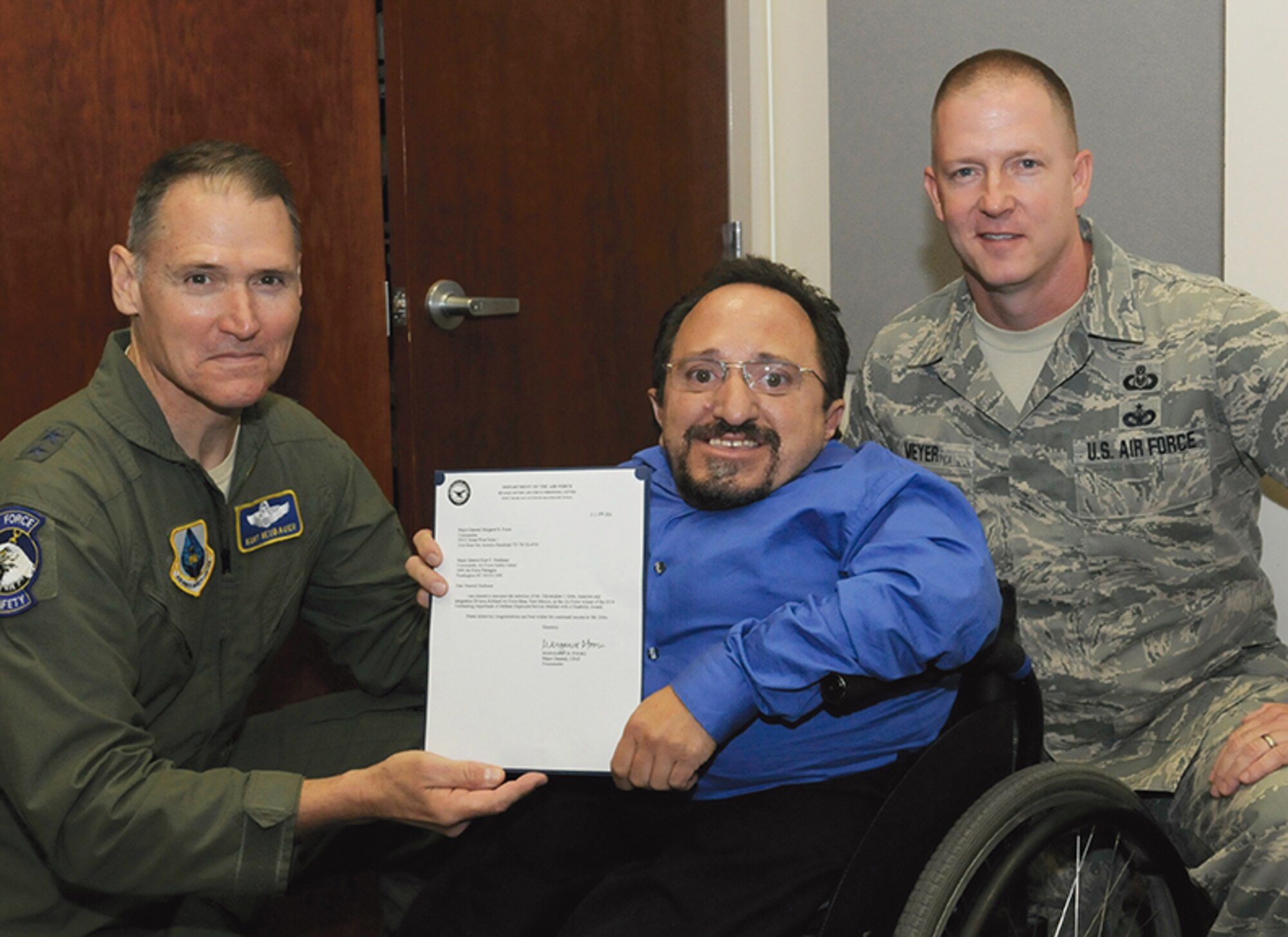 Christopher Gitto, a technical information specialist with the Air Force Safety Center, was recently named the Air Force winner of the Department of Defense Outstanding Employee with a Disability Award. He received the letter of notification from Maj. Gen. Kurt F. Neubauer, Air Force chief of safety and commander of the Air Force Safety Center, and CMSgt Charles Meyer, senior enlisted advisor, during the unit commander's call on July 10. (Photo by Airman 1st Class Aaron Brown)