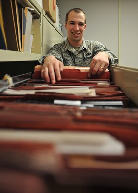 Airman 1st Class Ian Bush, 319th Civil Engineer Squadron command support staff journeyman, looks through construction files at the engineer and assistant file room on Dec. 4, 2014 on Grand Forks Air Force Base, N.D. Bush was name the 319th Air Base Wing Warrior of the Week for the first week of December 2014. (U.S. Air Force photo/Senior Airman Xavier Navarro)