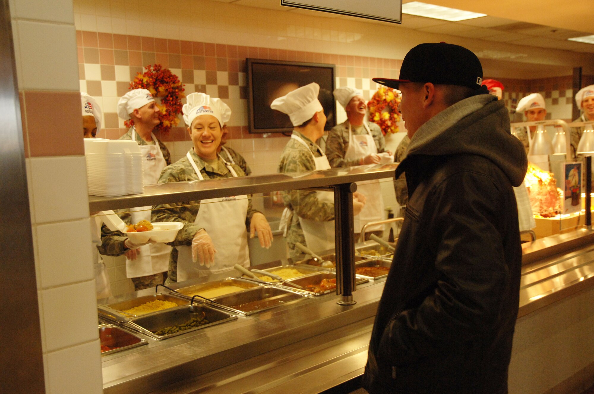 An Airman stands in line to receive a Thanksgiving meal at the Airey Dinning Facility on Grand Forks Air Force Base, N.D. on Nov. 27, 2014. Wing senior leaders, Superintendents and first sergeants spent the morning serving food to Airmen who are away from their families and loved ones. (U.S. Air Force photo/2nd Lt. James Fisher)