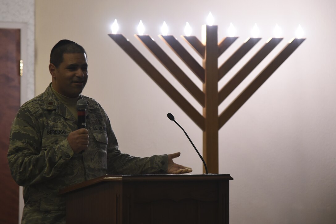 Chaplain (Maj.) Raphael Berdugo, 11th Wing deputy chaplain, tells the story of the Hanukkah Menorah during the Christmas Tree and Hanukkah Menorah Lighting on Joint Base Andrews, Dec. 3, 2014. The event featured storytelling, a performance by the Air Force Band, the tree and menorah lighting and was capped off by a special guest appearance. (U.S. Air Force photo/J.D. Maidens)