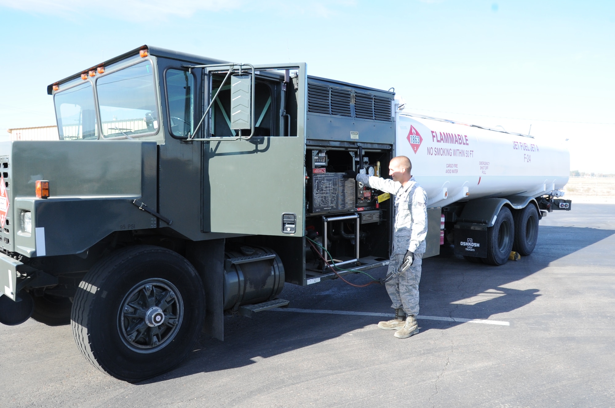 Senior Airman Jacob Hartman, 56th Logistic Readiness Squadron fuels distribution operator, checks out the newly painted R-11 refueling truck at the LRS vehicle yard. After receiving waiver approval from the Air Education and Training Command, the 56th LRS had the truck painted white to keep the fuel inside from overheating. The F-35 Lightning II joint strike fighter has a fuel temperature threshold and cannot function properly if the fuel temperature is too high. (U.S. Air Force photo/Staff Sgt. Luther Mitchell Jr.)