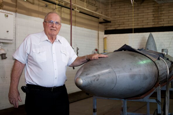 Retired Chief Master Sgt. John Burden stands with a 300-gallon centerline fuel tank Nov. 24 at 56th Component Maintenance Squadron on Luke Air Force Base. When he was a buck sergeant, Burden worked as a fuel systems apprentice in 1969 at Luke AFB. (U.S. Air Force photo/Staff Sgt. Staci Miller)