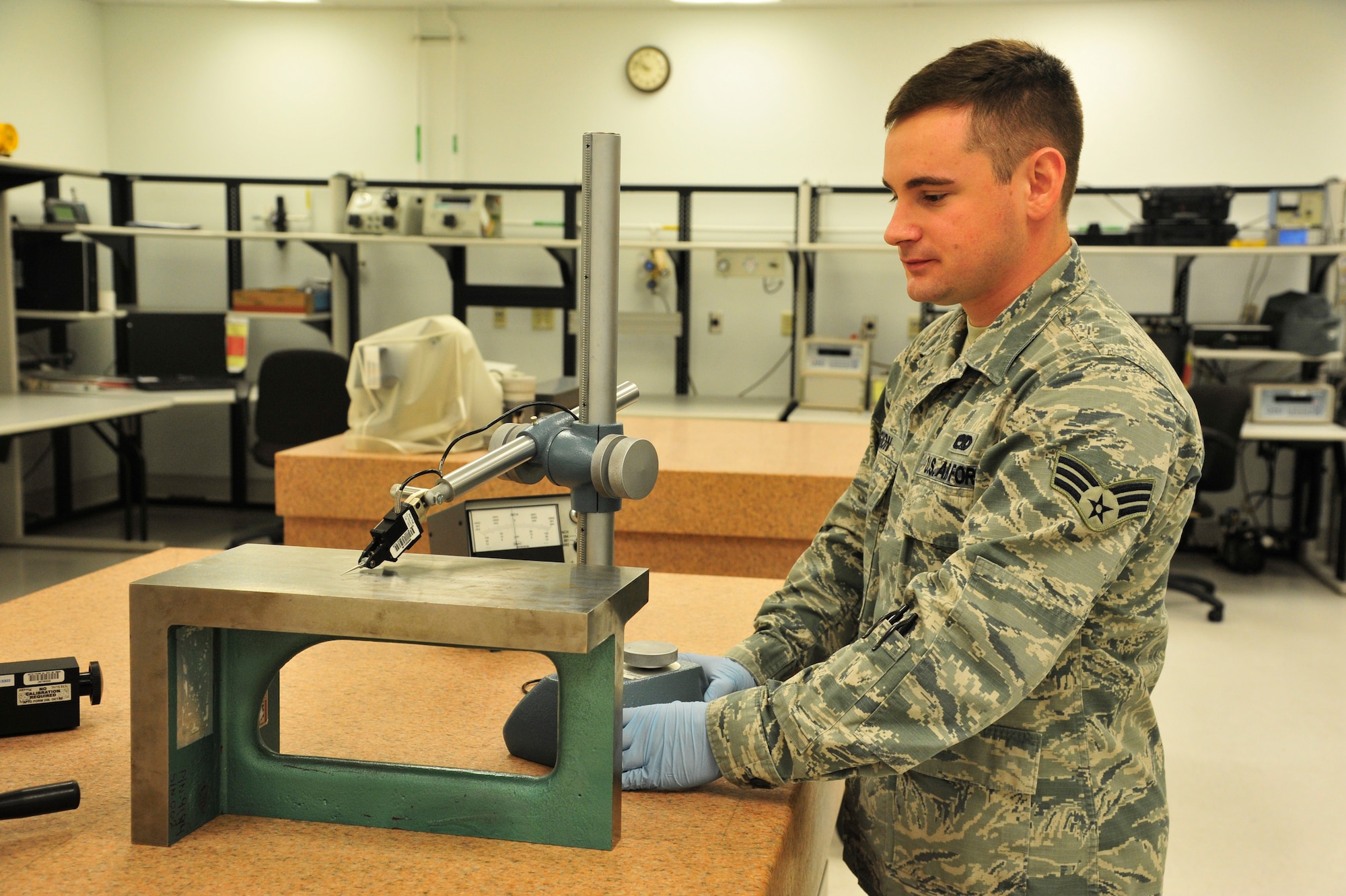 Senior Airman Jacob Gagnon, 56th CMS PMEL journeyman, checks the parallelism of an angle plate using a height gauge Nov. 17 in Bldg. 417 at Luke Air Force Base. The surface Gagnon is working on is called a granite surface plate and is calibrated to an accuracy of 500 micro inches. (U.S. Air Force photo/Senior Airman Grace Lee)