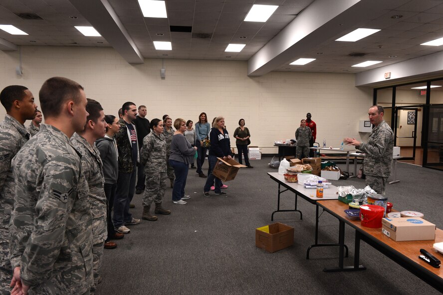 U.S. Air Force Col. Stephen Jost, 20th Fighter Wing commander, speaks to a group of volunteers during a holiday cookie drive at Shaw Air Force Base, S.C., Dec. 4, 2014. Jost spoke to the more than 30 Team Shaw volunteers, thanking them for their contribution and hard work, providing and packaging approximately 45,000 cookies to be sent to deployed service members. (U.S. Air Force photo by Airman 1st Class Jensen Stidham/Released)